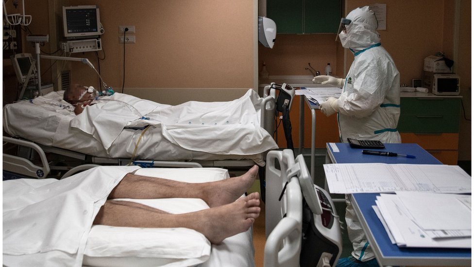 A doctor attends to patients in intensive care in the Covid-19 ward of the Maria Pia Hospital in Turin on 7 April 2020.