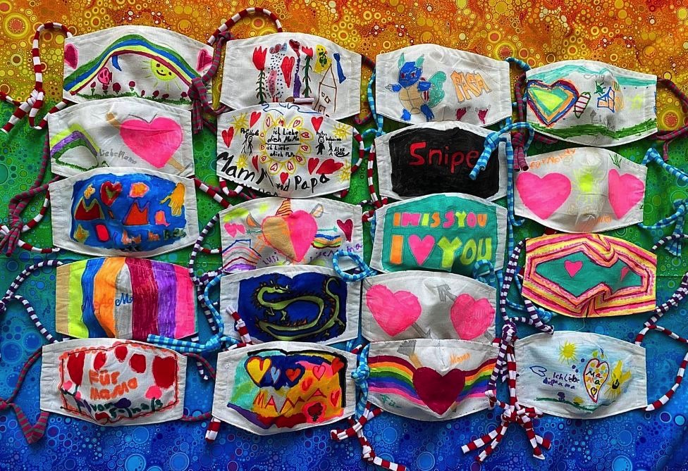 Masks coloured by pupils at the Waldhausschule in Germany