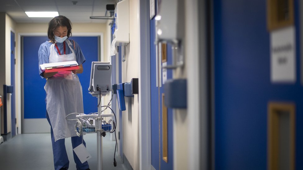 A doctor checks on patient notes