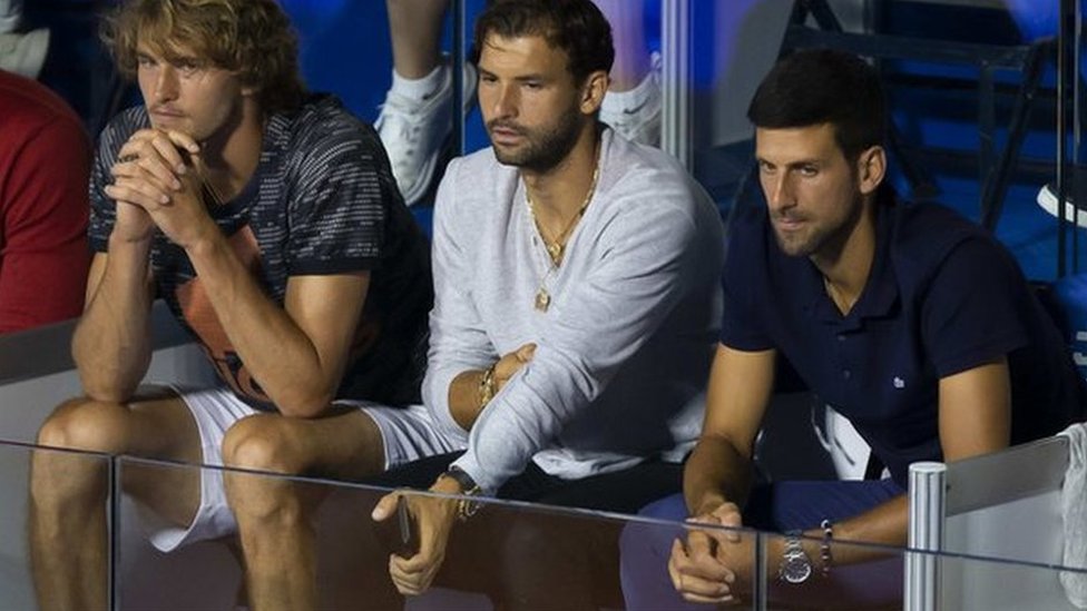 Grigor Dmitrov seated next to Novak Djokovic