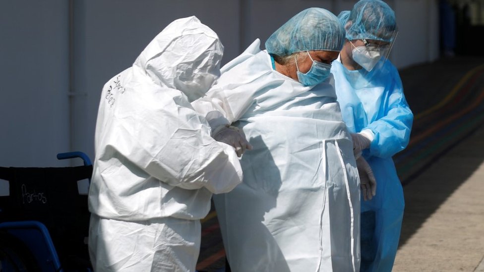 A woman is discharged from the hospital after surviving the coronavirus disease in Santa Tecla, El Salvador 26 June 2020