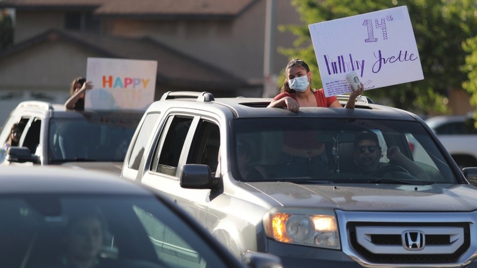 Friends line up to wish Yvette Torres, 14, a happy birthday at a drive-by party outside her home as the global outbreak of coronavirus (COVID-19) continues, in Pico Rivera, near Los Angeles, California, U.S., April 27, 2020