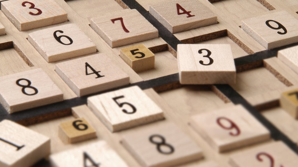 Close up of a wood Sudoku Game Board with puzzle in progress