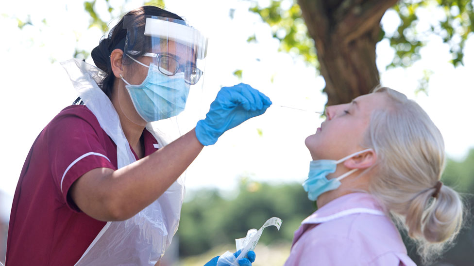 A health care assistant having a test