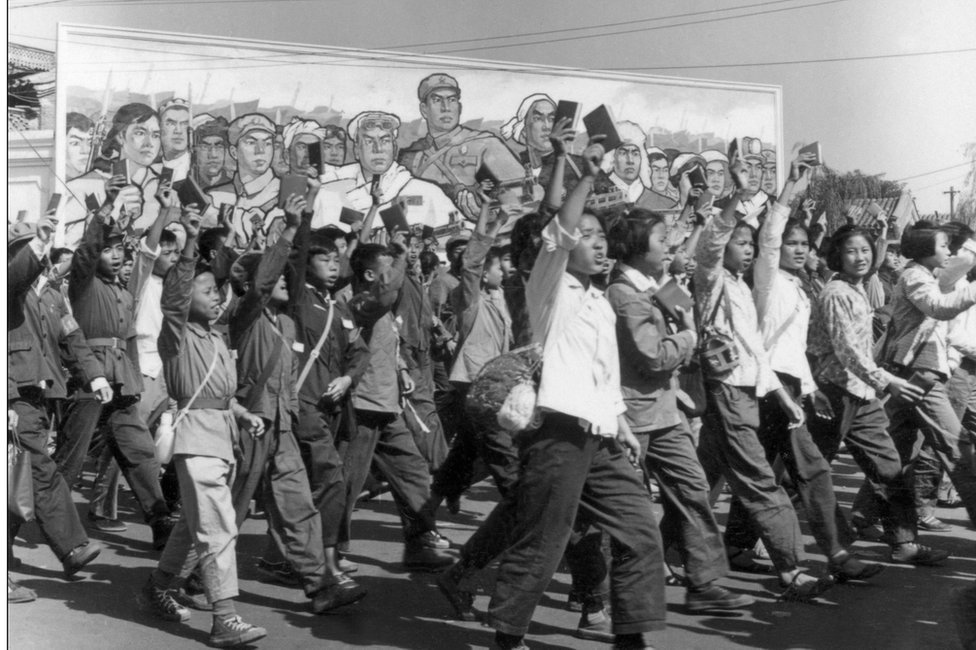 School and university Red Guards, waving copies of Chairman Mao's "Little Red Book", in a June 1966 parade in Beijing