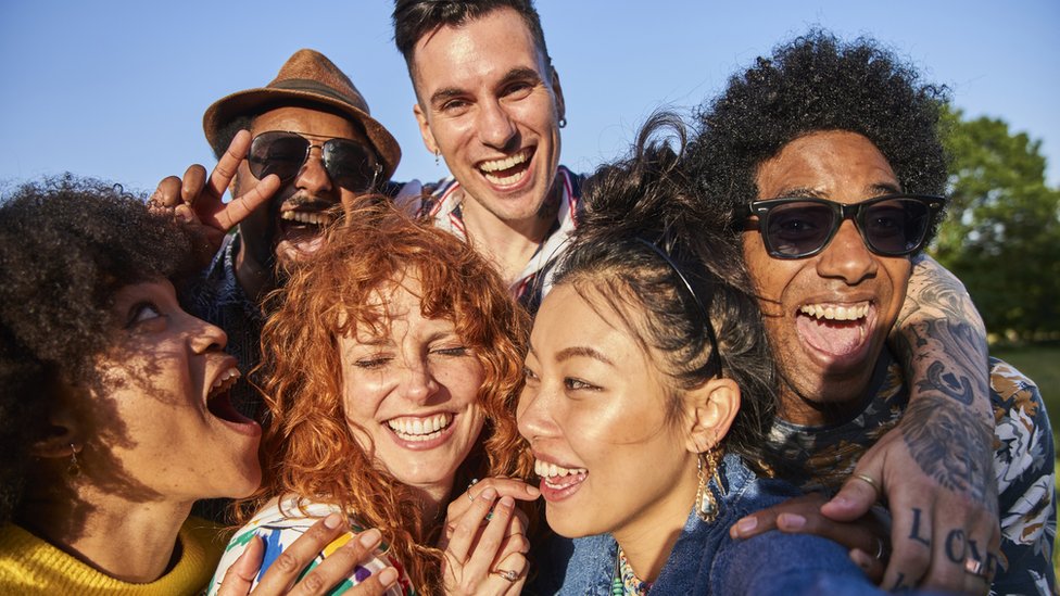 Group of friends hugging and having fun