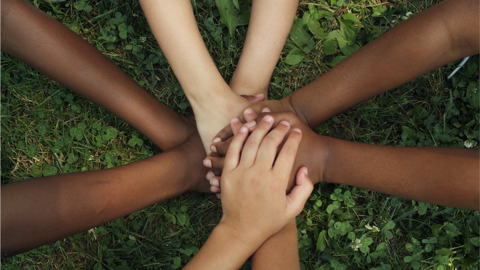 Group of children join hands