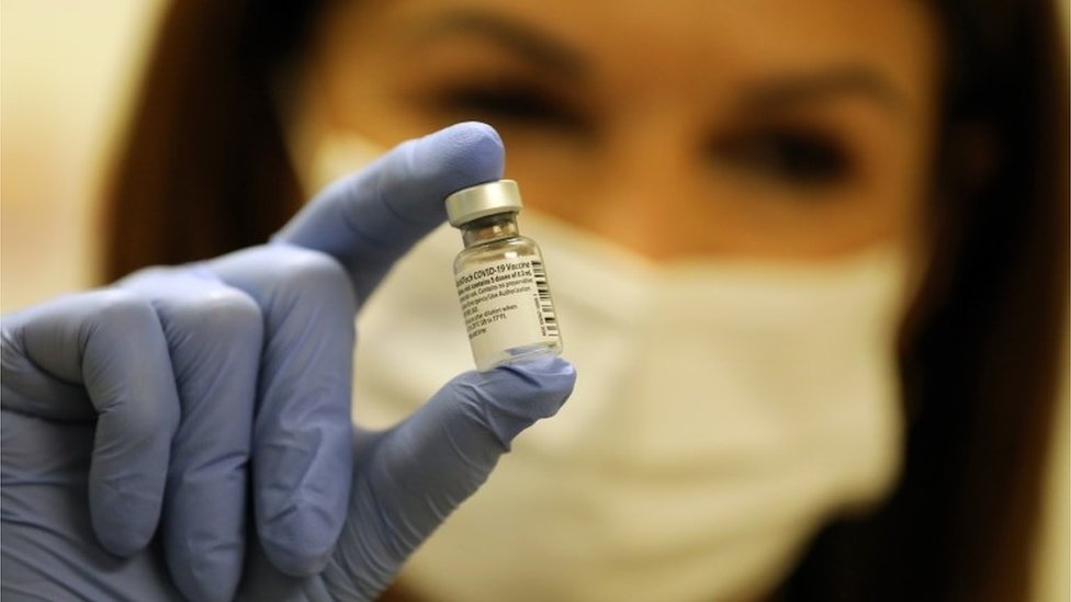 A nurse shows a vial of Pfizer-BioNTech Covid-19 vaccine in Jerusalem, 20 December