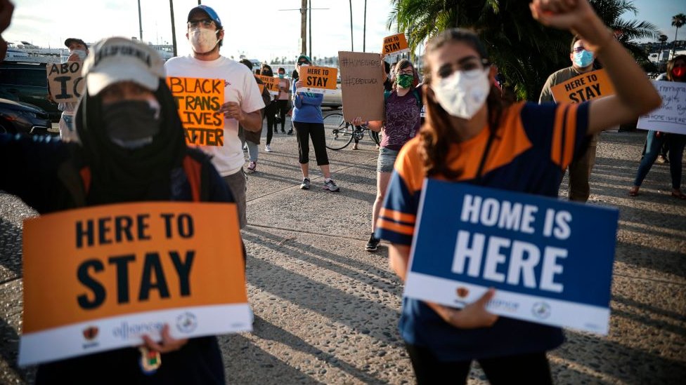 People hold signs during a rally in support of the Supreme Court's ruling in favor of the Deferred Action for Childhood Arrivals programme in San Diego, California