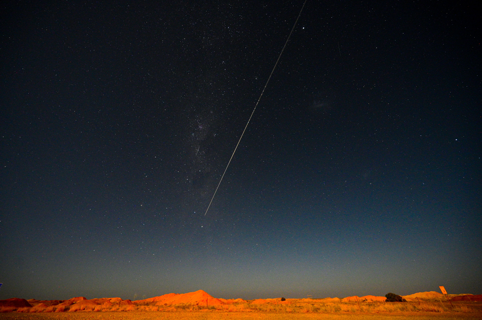 A capsule from Japan's Hayabusa-2 space probe streaks through the night sky