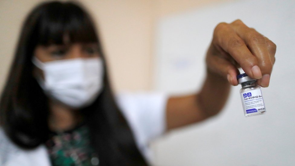 A medical worker holds a vial of the Russian Sputnik V coronavirus vaccine