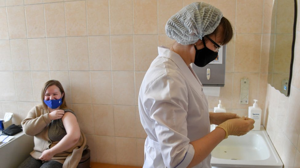 A woman receives an injection of component 2 of the Sputnik V vaccine