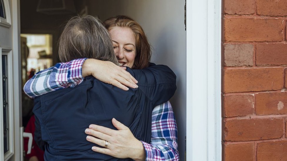 A single mother hugs her mother and shares a tender bonding moment with each other.