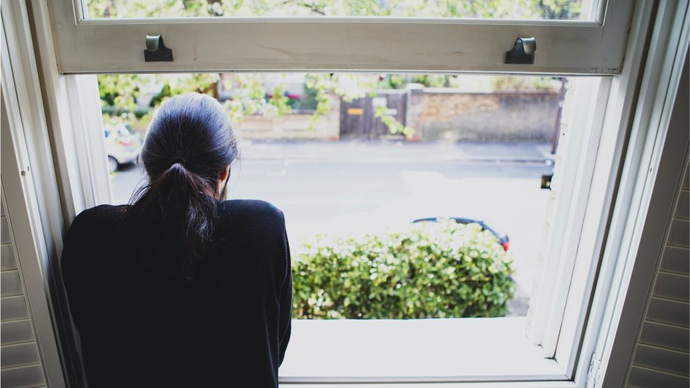 Man looking outside through a window