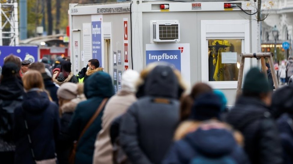 People wait in front of a vaccination point