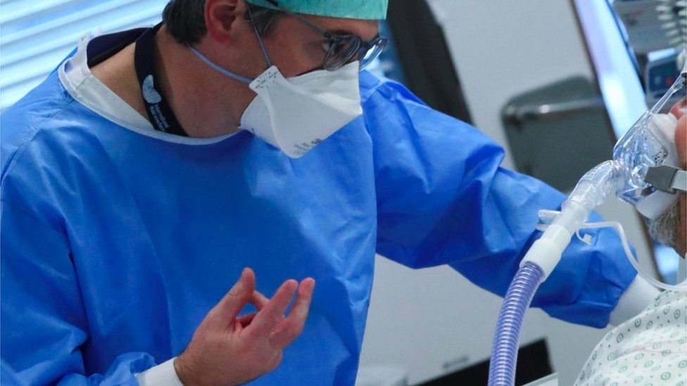 A medical worker treats a patient at a hospital in Antwerp