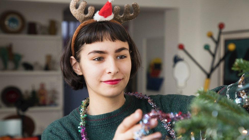 Woman decorating Christmas tree