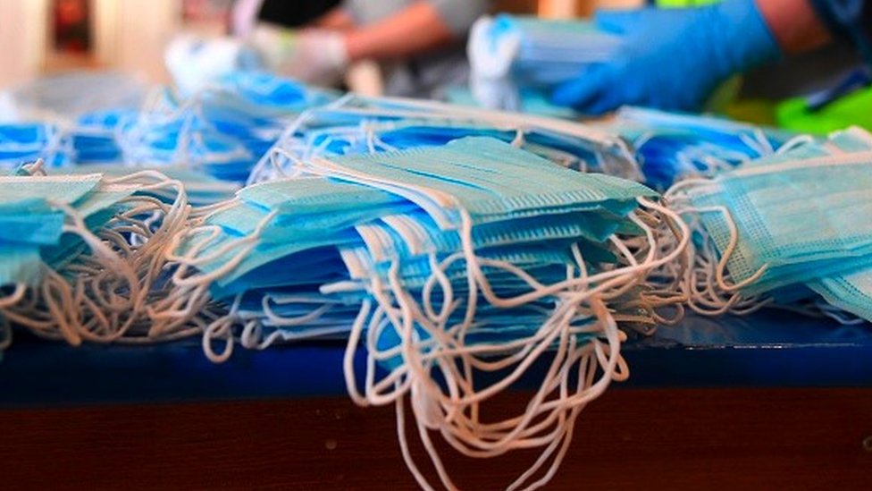 Disposable face masks stacked on a table