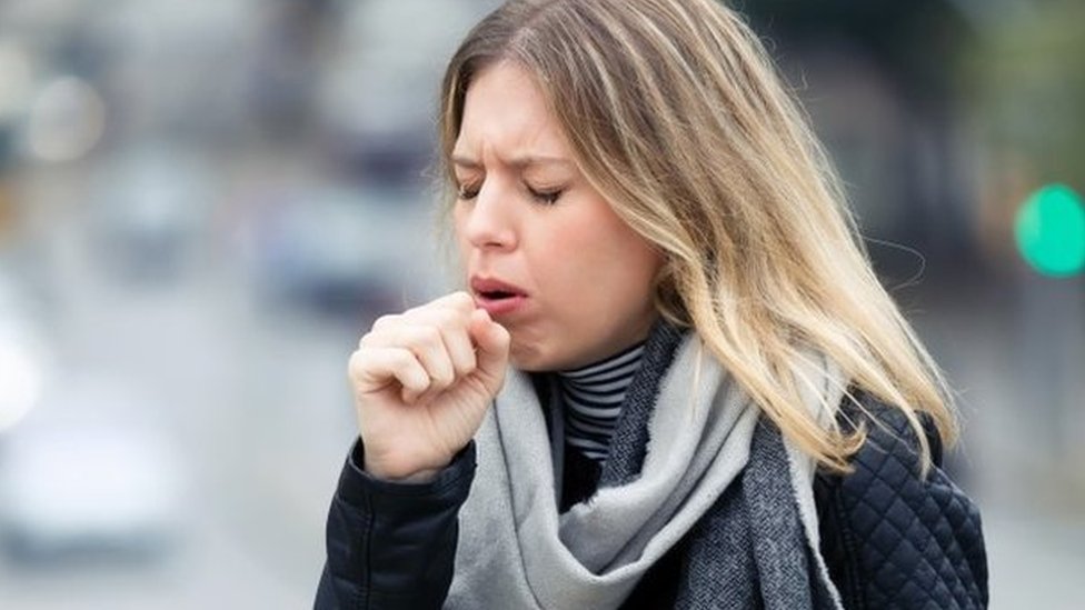 A woman coughing